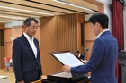 中野市長から表彰状を受け取る大興建設の佐藤伸二社長（左）